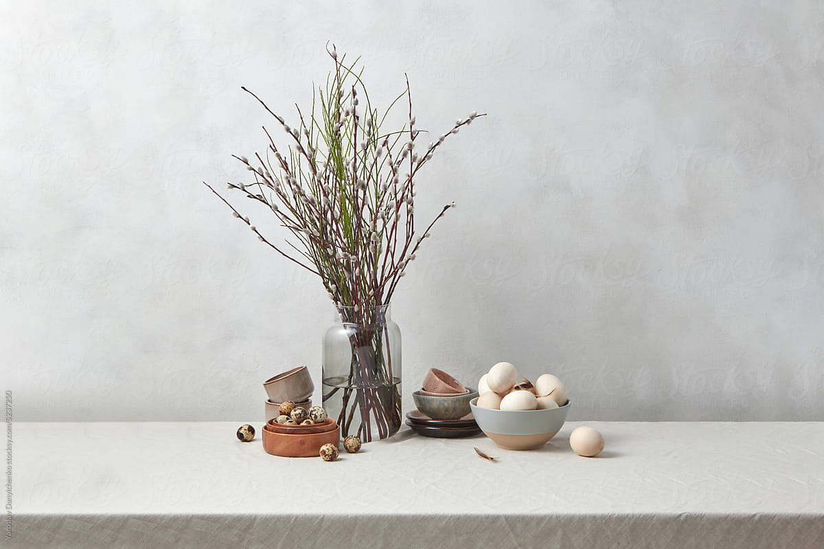 Willow branches with wooden eggs and porcelain.
