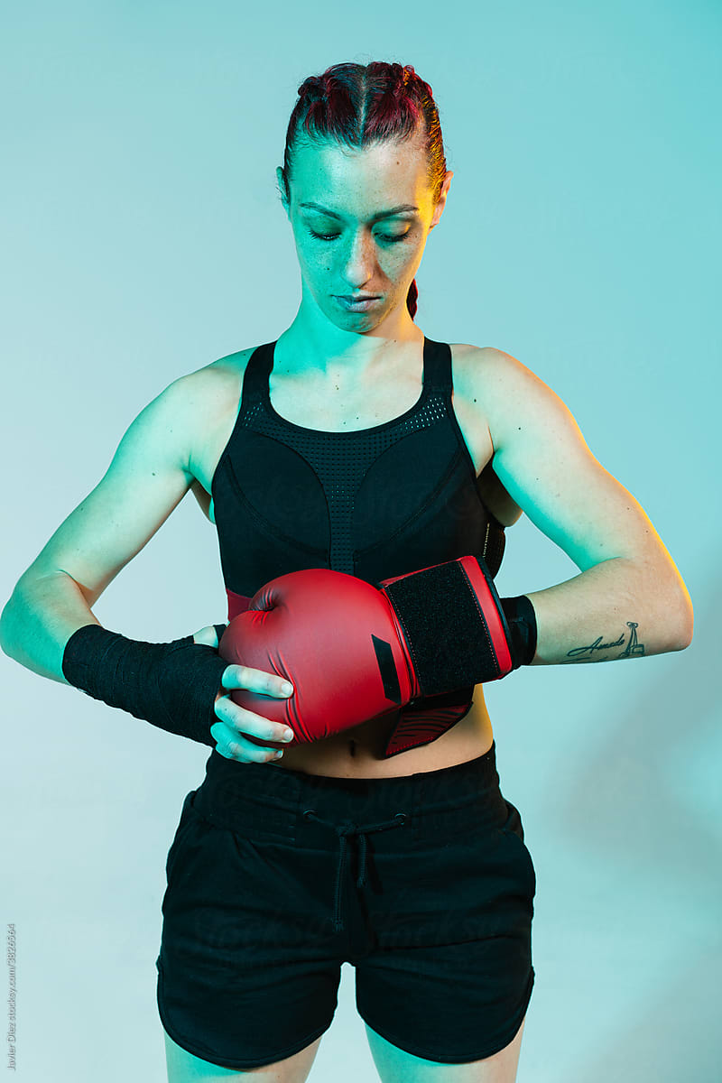Confident sportswoman with boxer gloves
