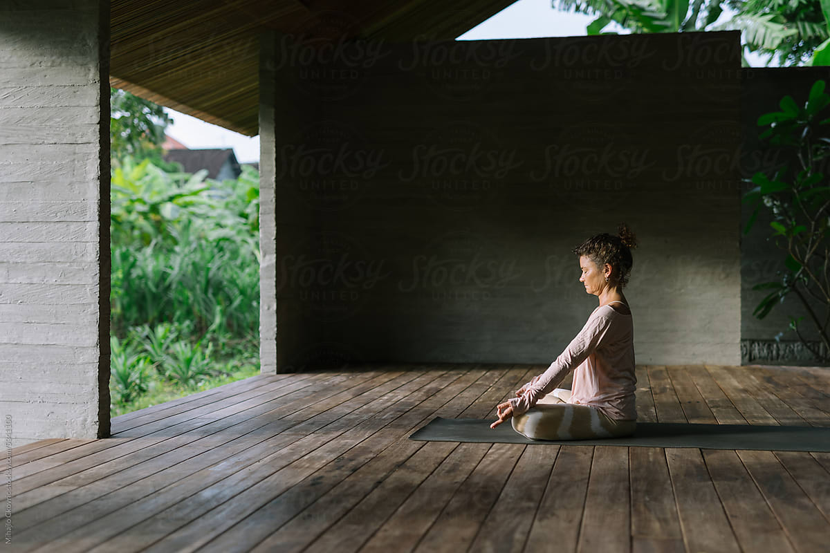 Adult Yogi Woman Meditating In Yoga Studio In The Morning by Stocksy  Contributor Mihajlo Ckovric - Stocksy