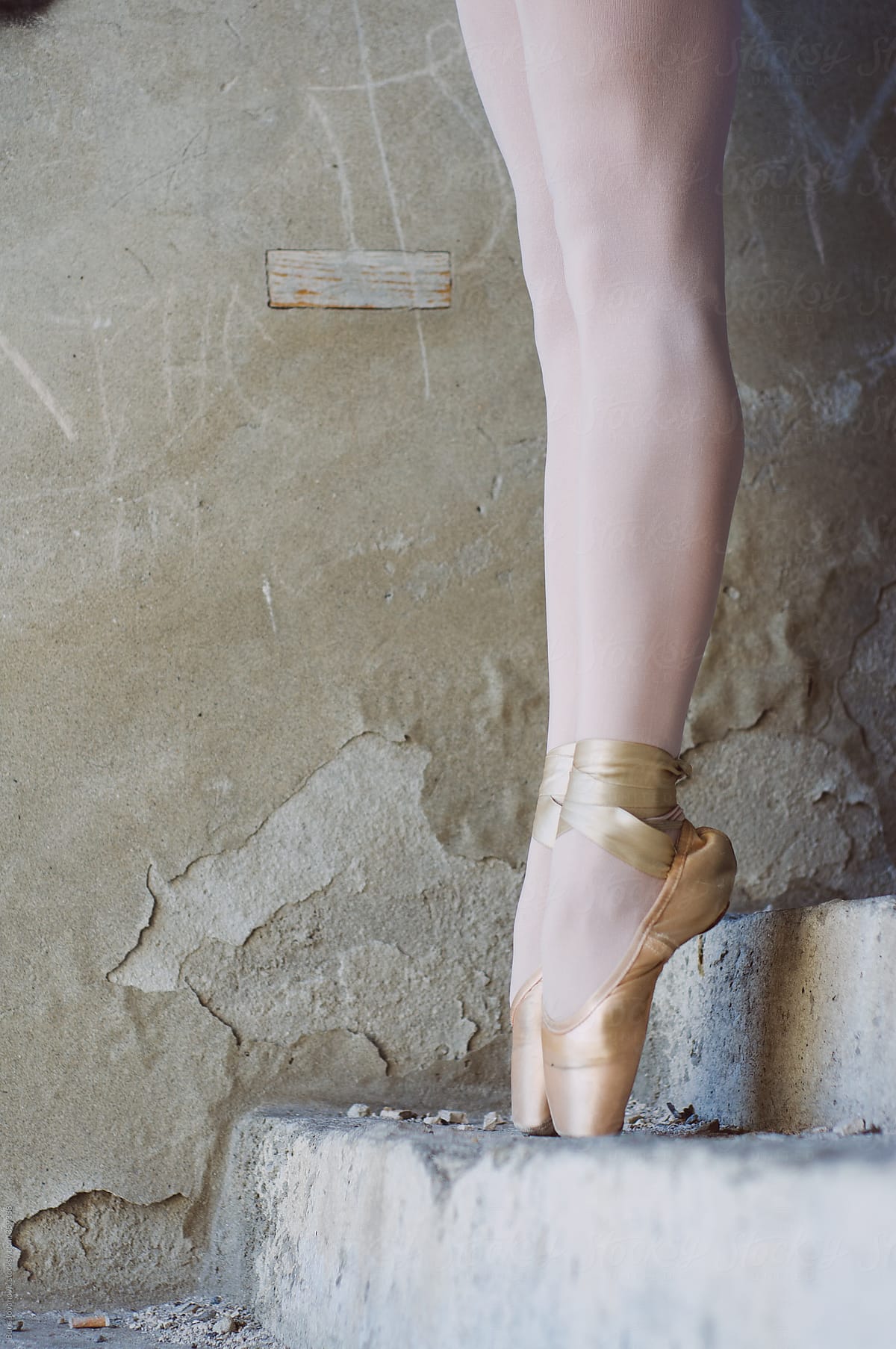 Ballerinas legs on old stairs