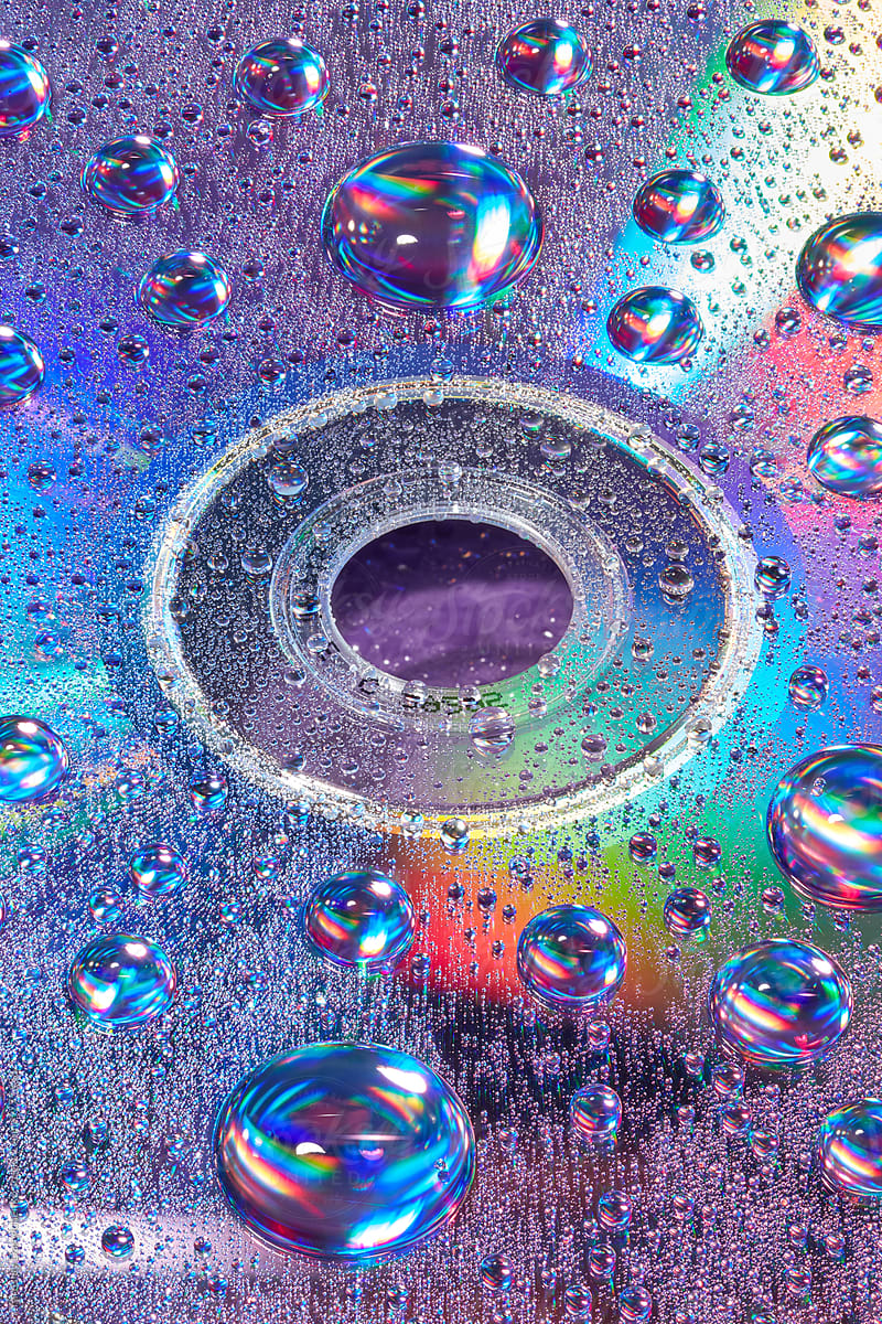 Rainbow water drops on plastic CD disc as seamless pattern