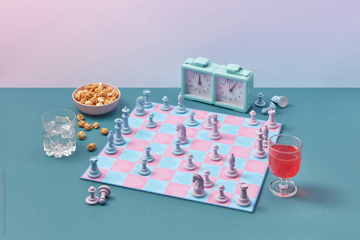 Heart patterned chess set with party snacks.