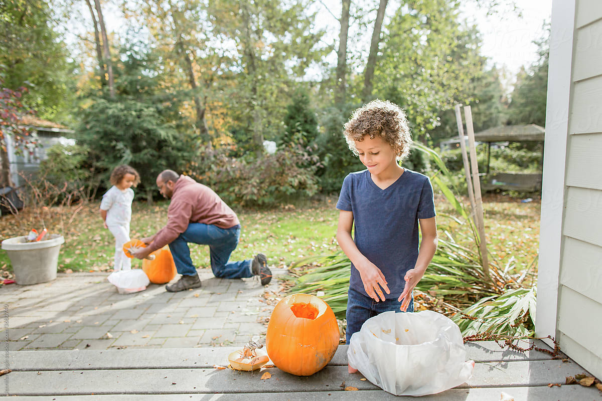 Family empties pumpkins for carving