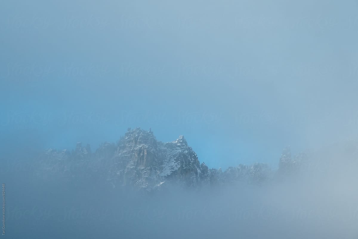 Snowy peak through fog