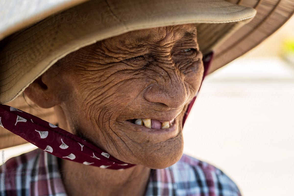 Old lady in hat and band under chin smiling away