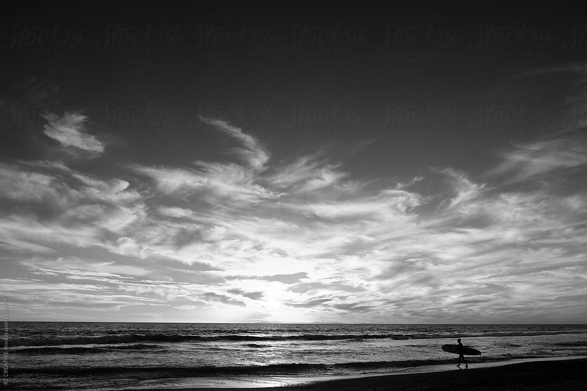 Black and white surfer at beach.
