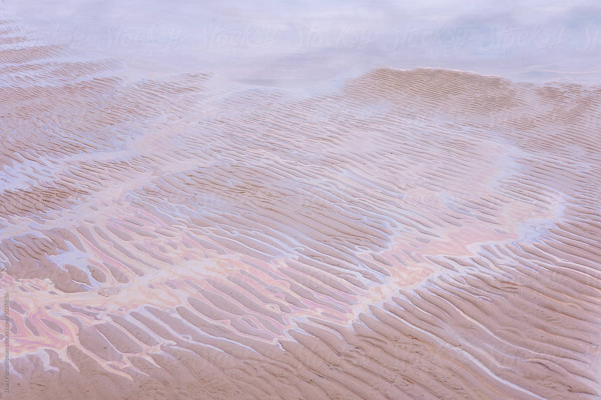 Oil stain on the beach sand.