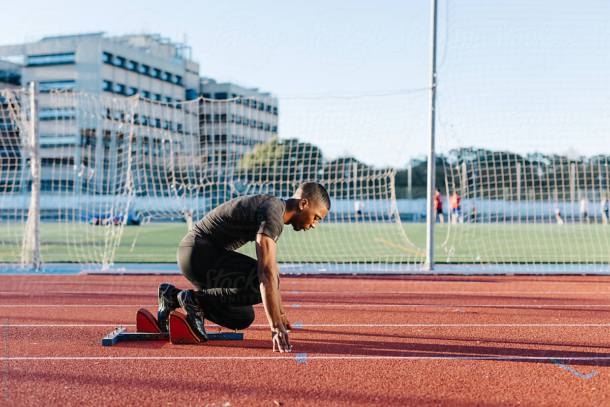 Black sportsman preparing to run race