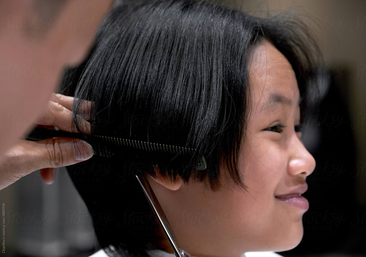 Asian Chinese little girl getting a haircut
