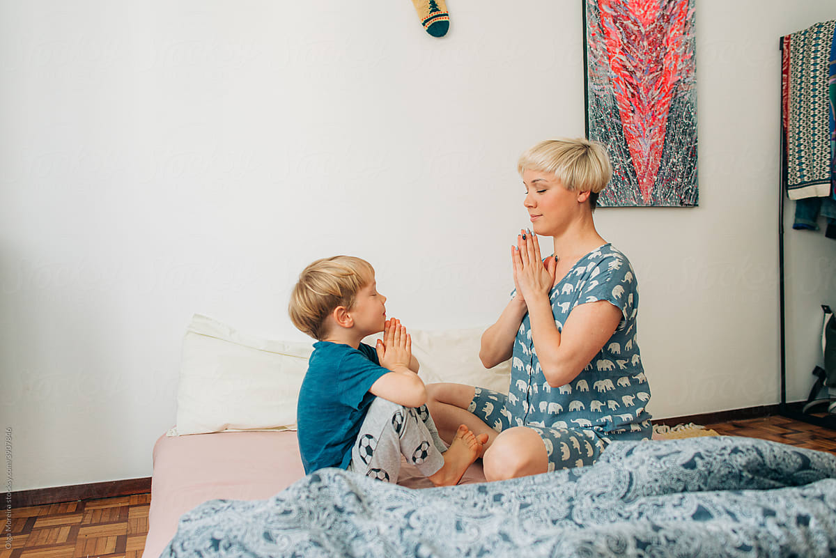 Mother teaching her son meditation
