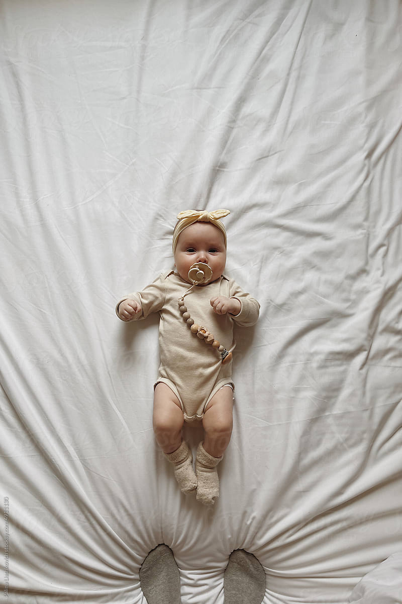 Baby portrait on white sheets.