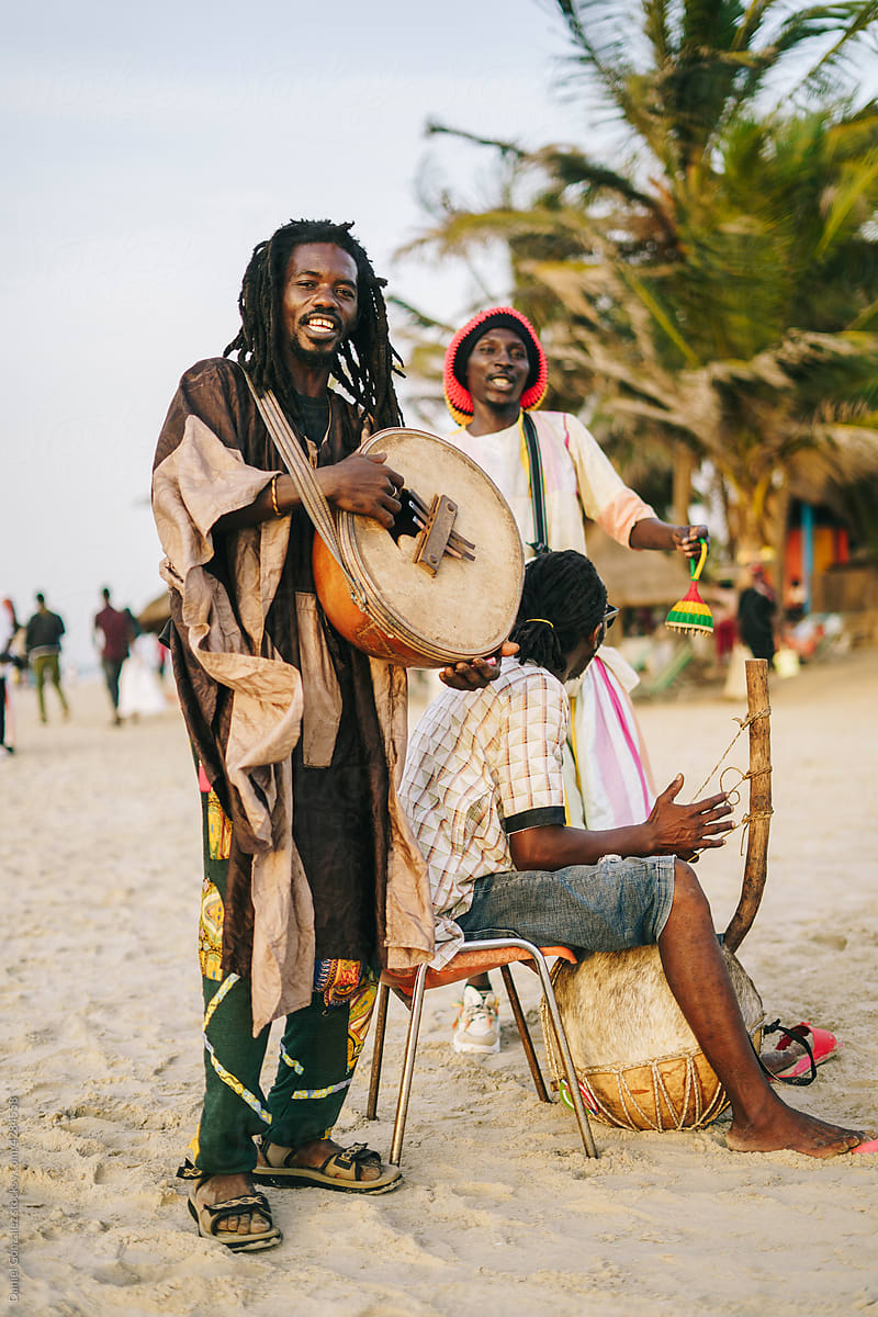 Smiling black musicians playing African melodies