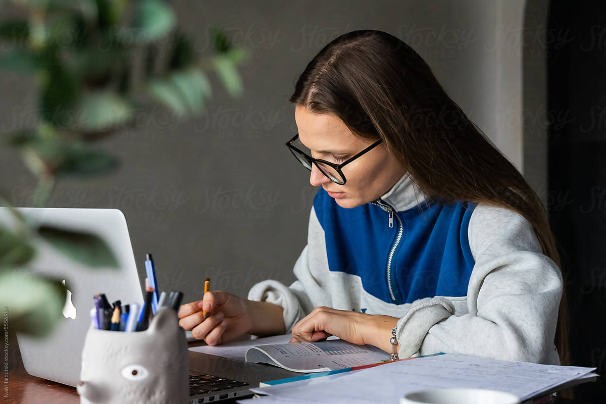 Focused college school girl preparing for test exam books