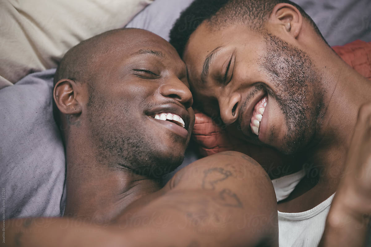 Black Gay Male Couple At Home In Bed by Joselito Briones.