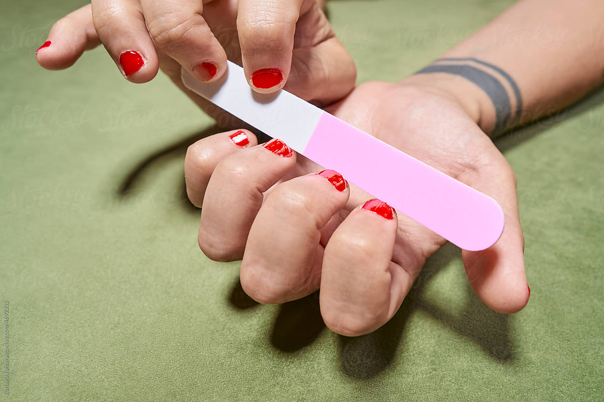 A transgender man filing his nails