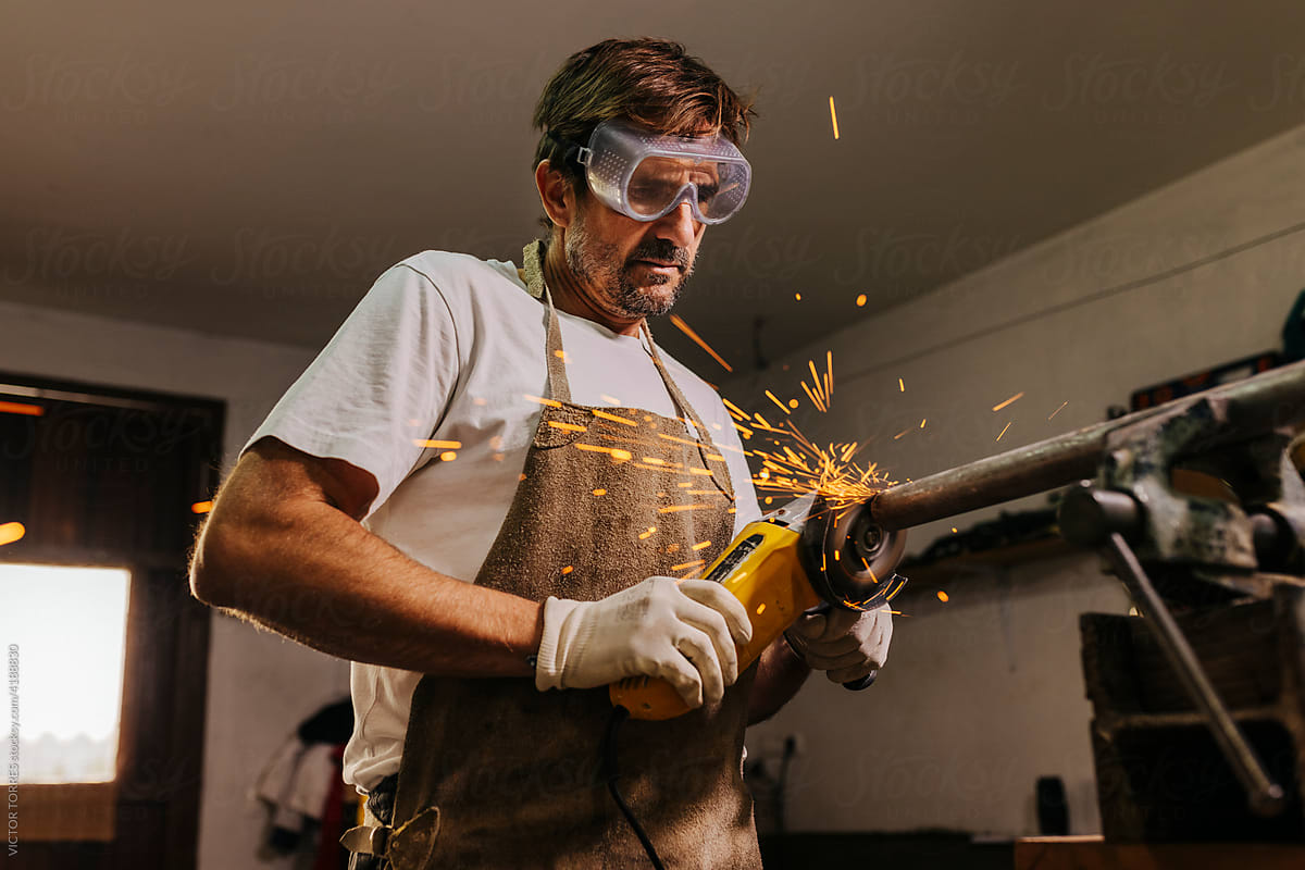 Professional carpenter working with metal parts