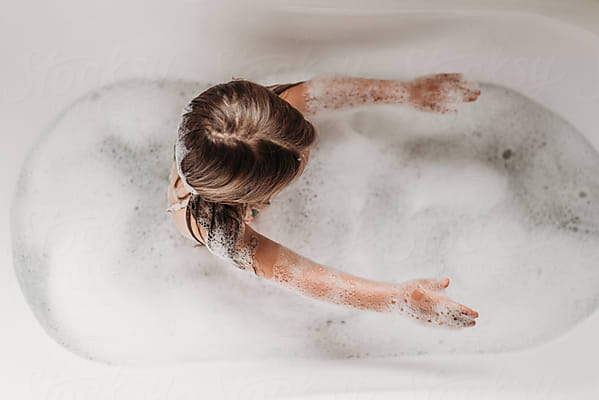 Toddler In Bubble Bath by Stocksy Contributor Kelsey Smith