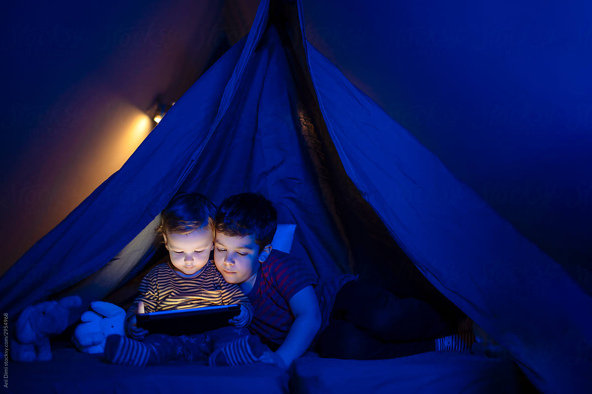 Kids with tablet under teepee