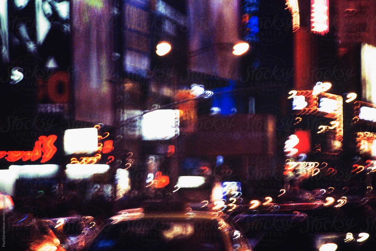 Blurred nighttime view of traffic and lights in Times Square, NY, NY, USA