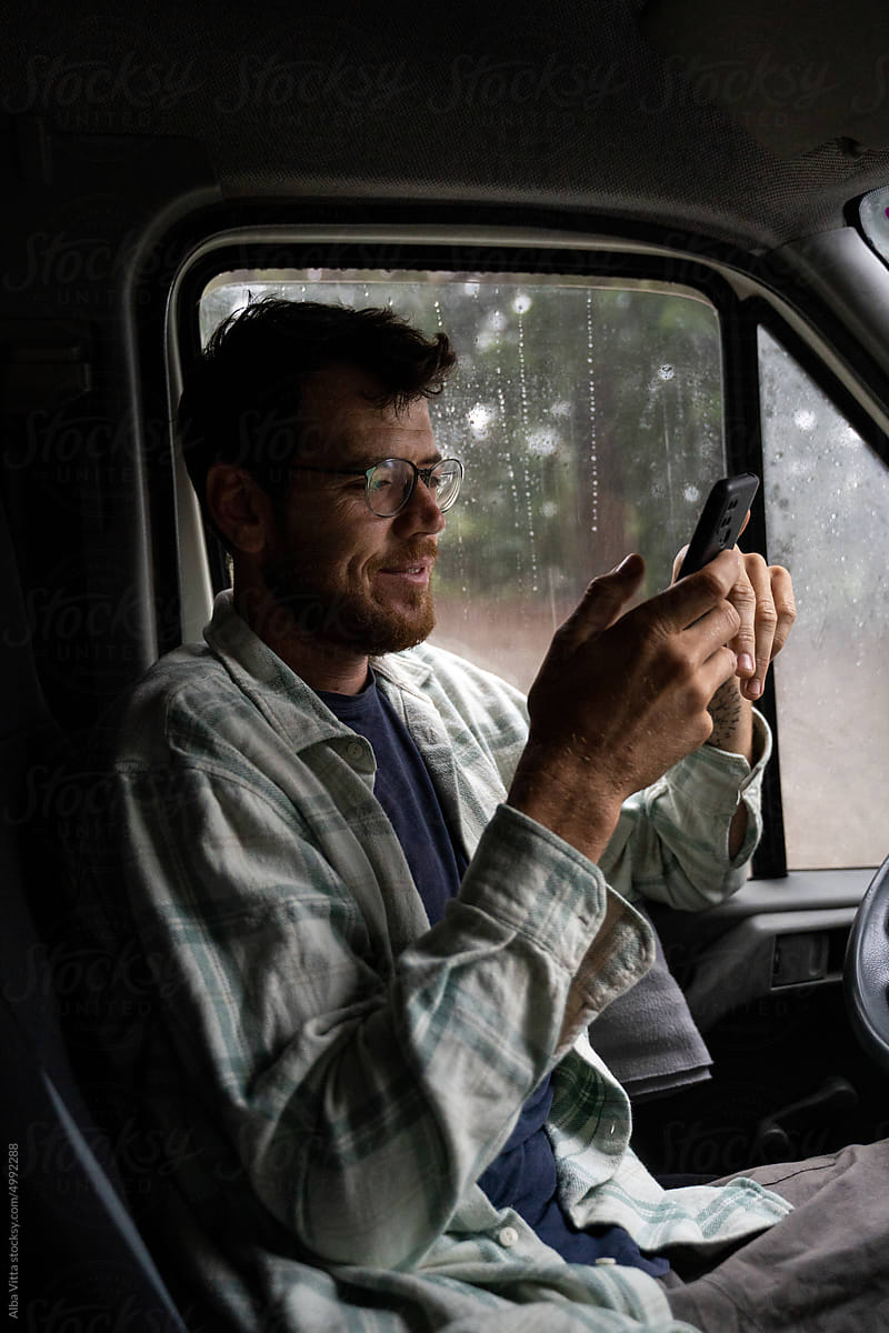 Man using phone inside car