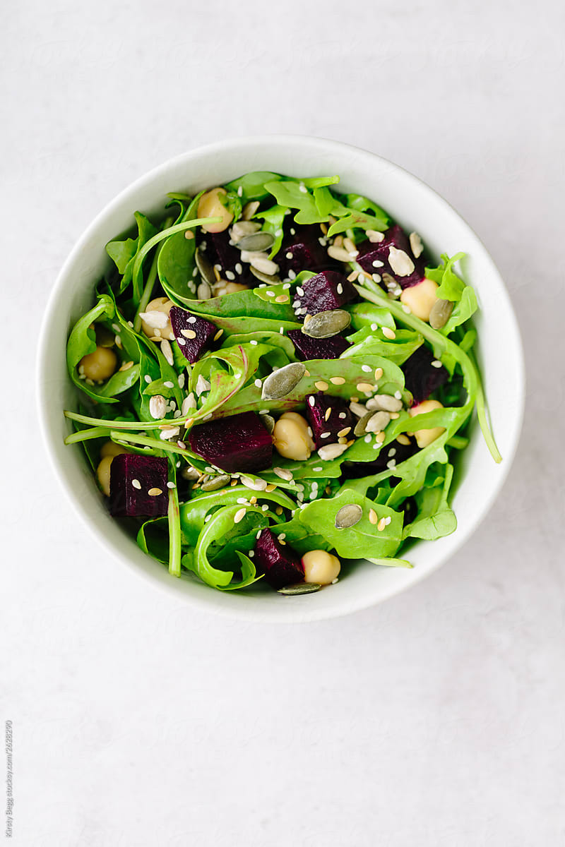 Vegan beetroot salad with spinach, rocket, chickpeas and seeds