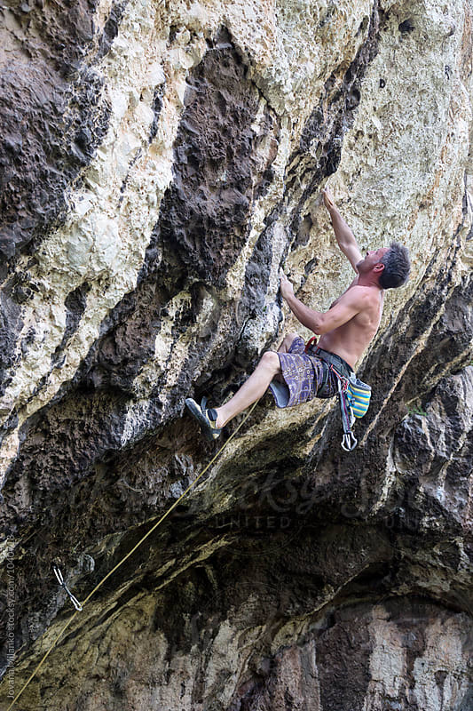 Free climber leading a route on a natural rock outdoor