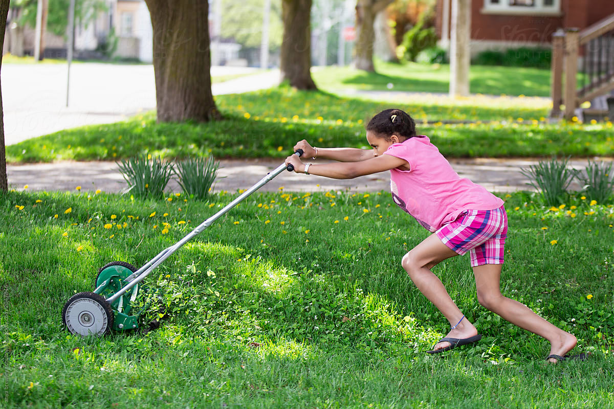 Girl using a push lawn mower