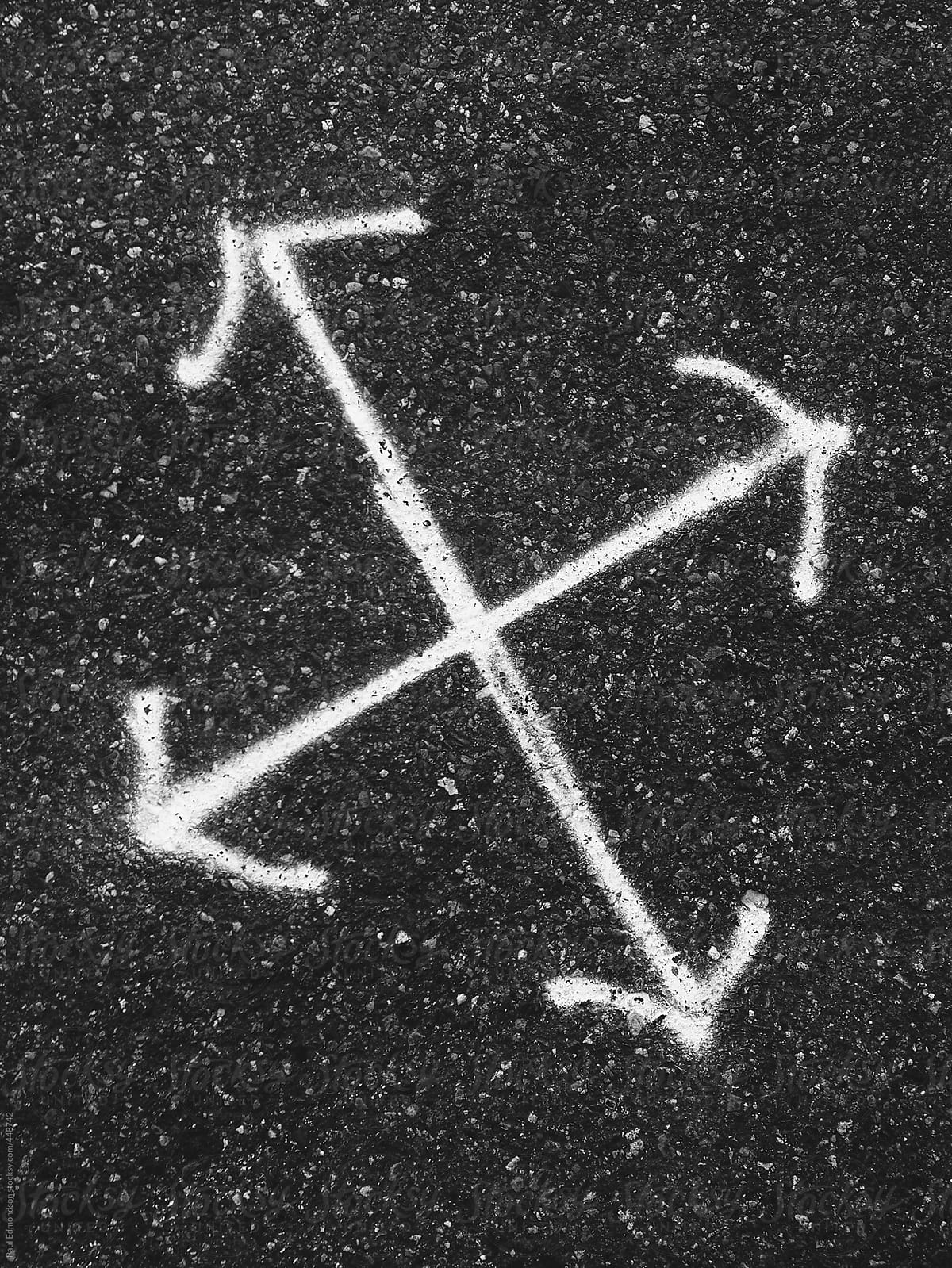 Directional arrows spray painted on urban street