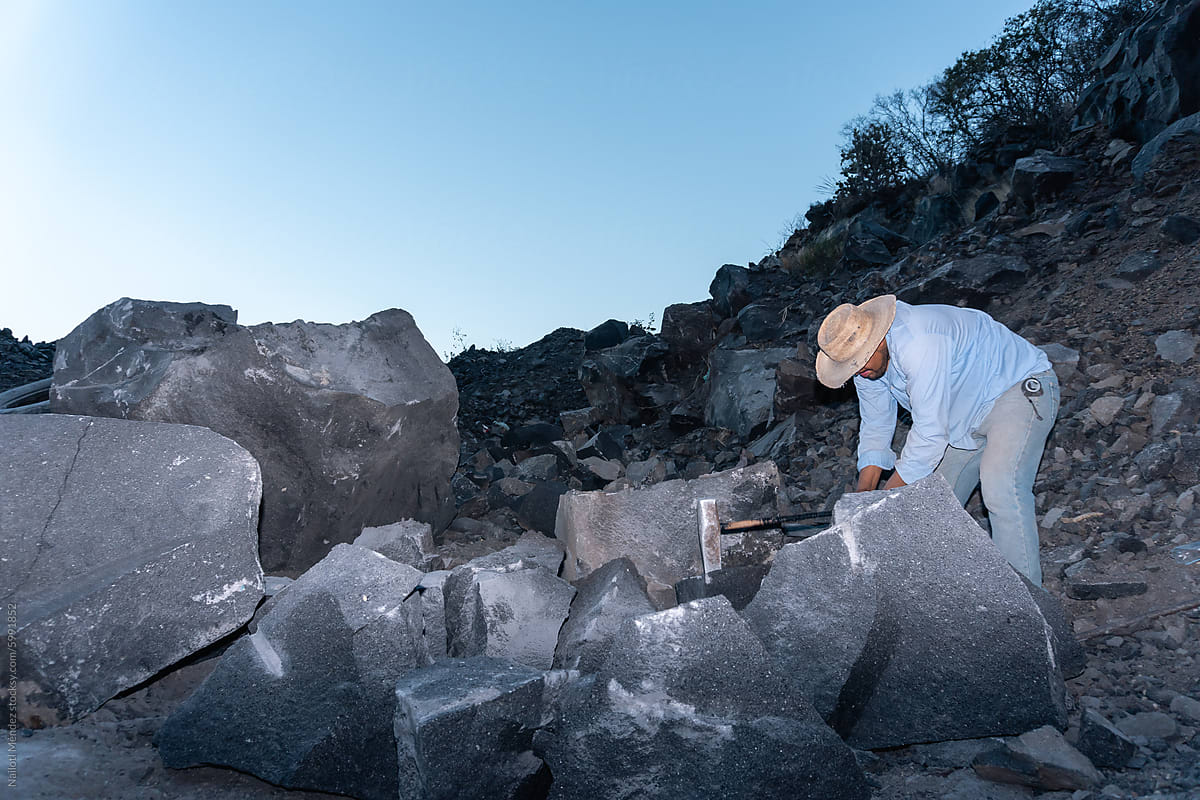 Miner Extracting Volcanic Rocks