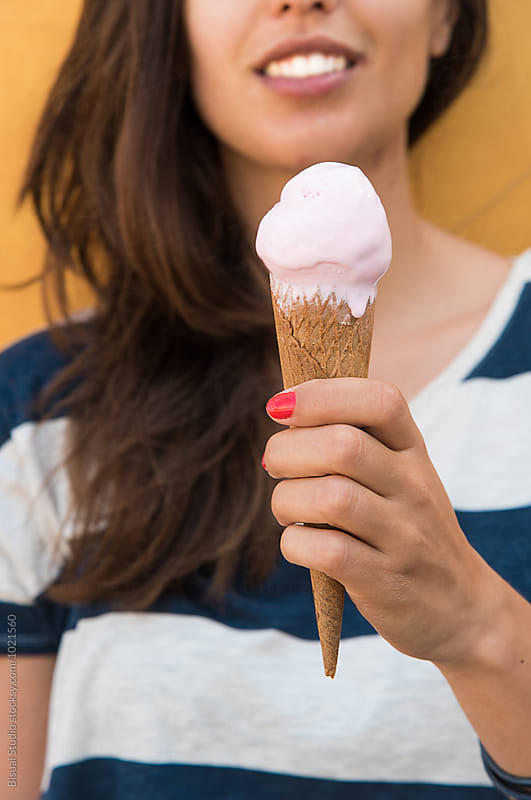 Young woman holding an ice cream