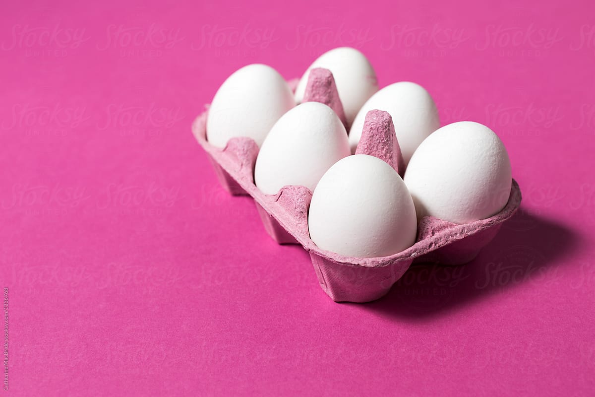 six white eggs on pink