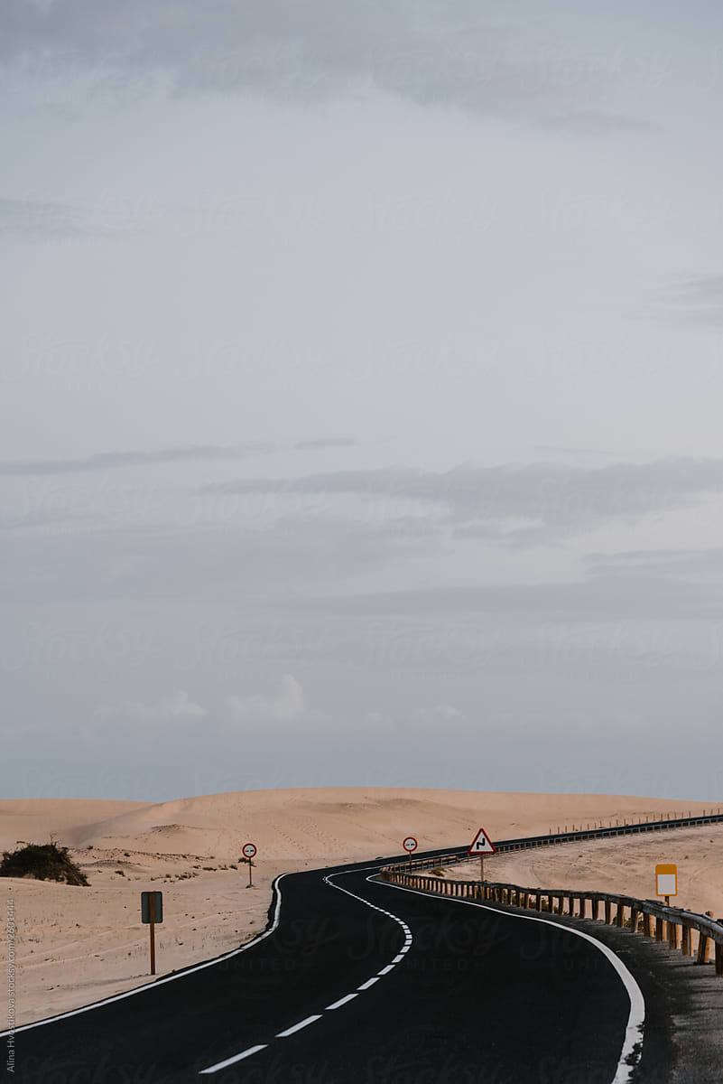Empty road among sand on Island.