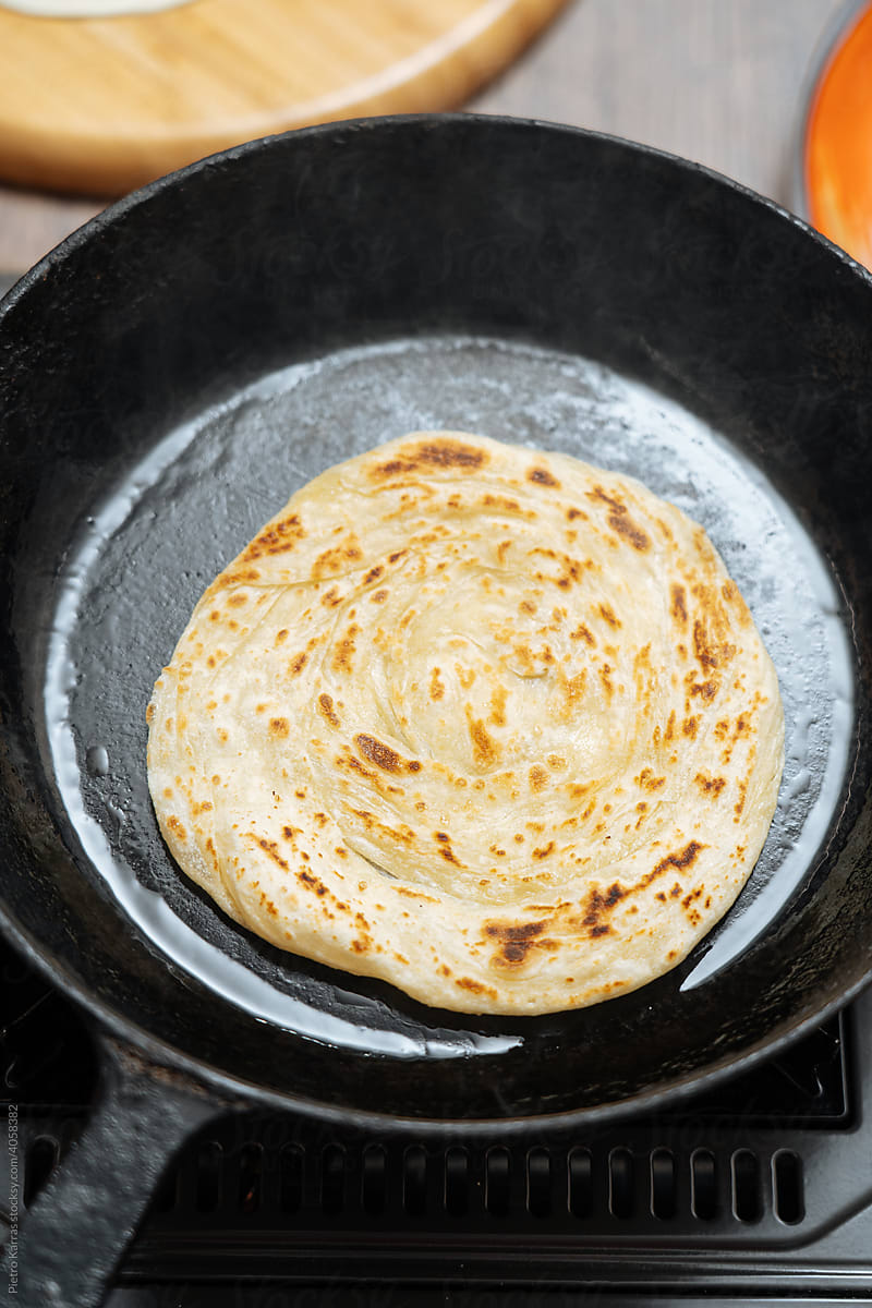 Indian flatbread is frying on a pan