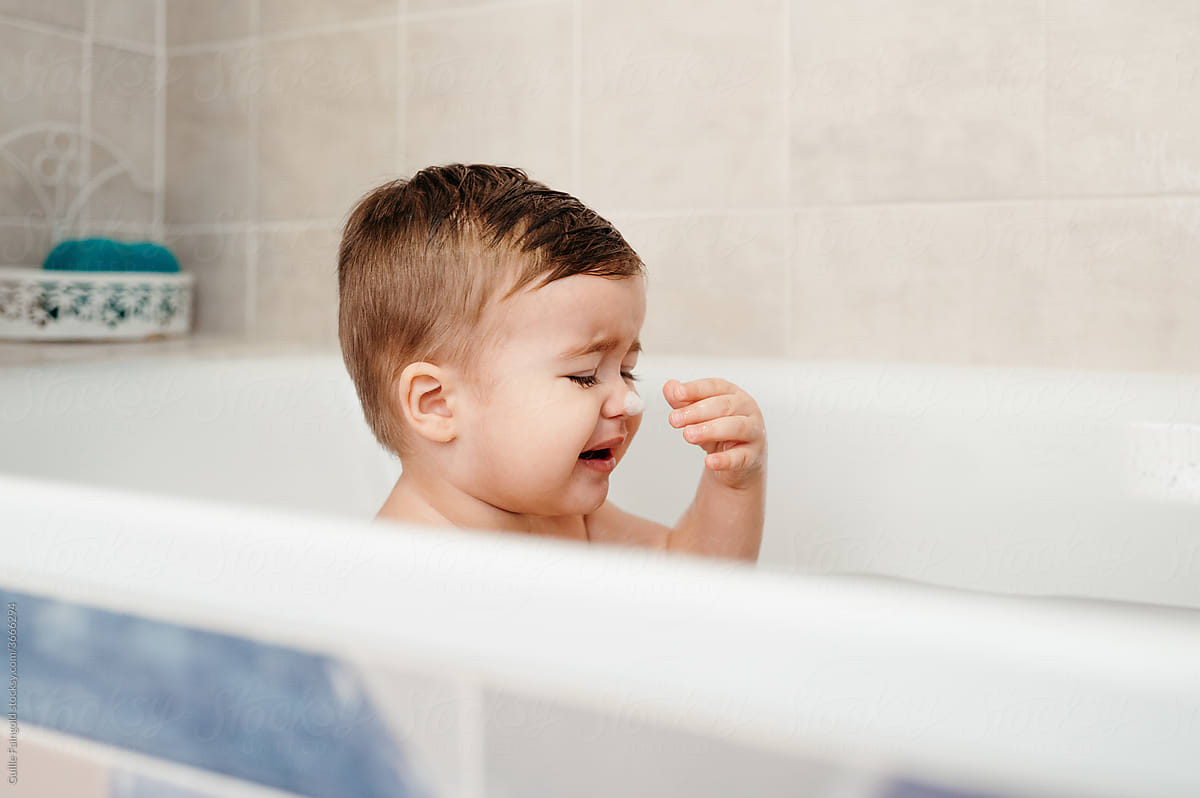 Toddler crying in bathtub during hygienic routine