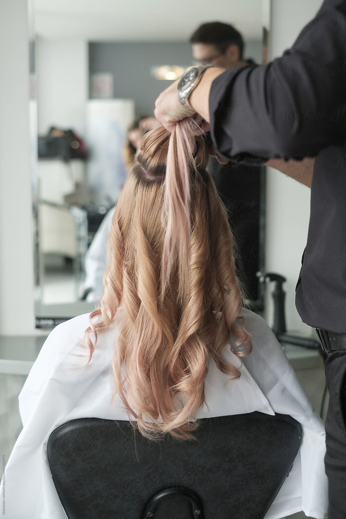 Hairdresser Working On A Customer\'s Hair With A Curling Iron