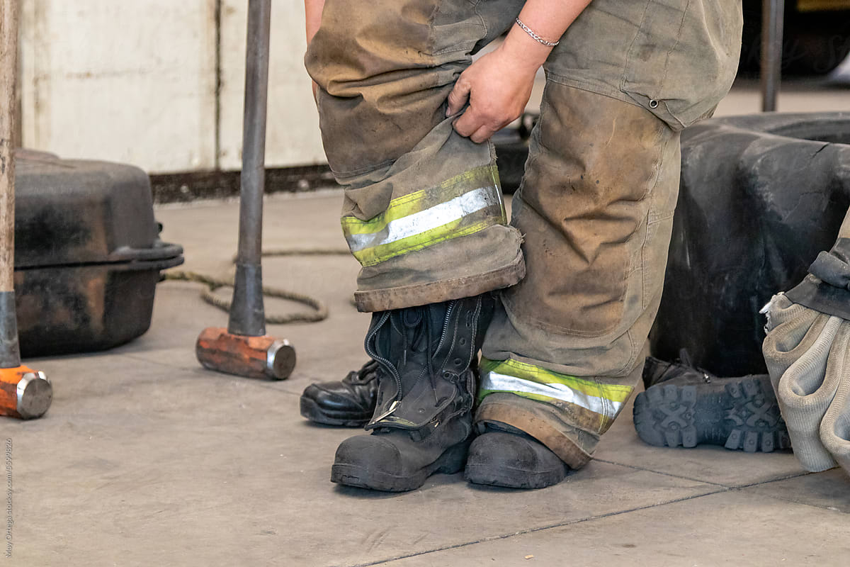 Close Up Of A Firefighter Putting On His Uniform Boots