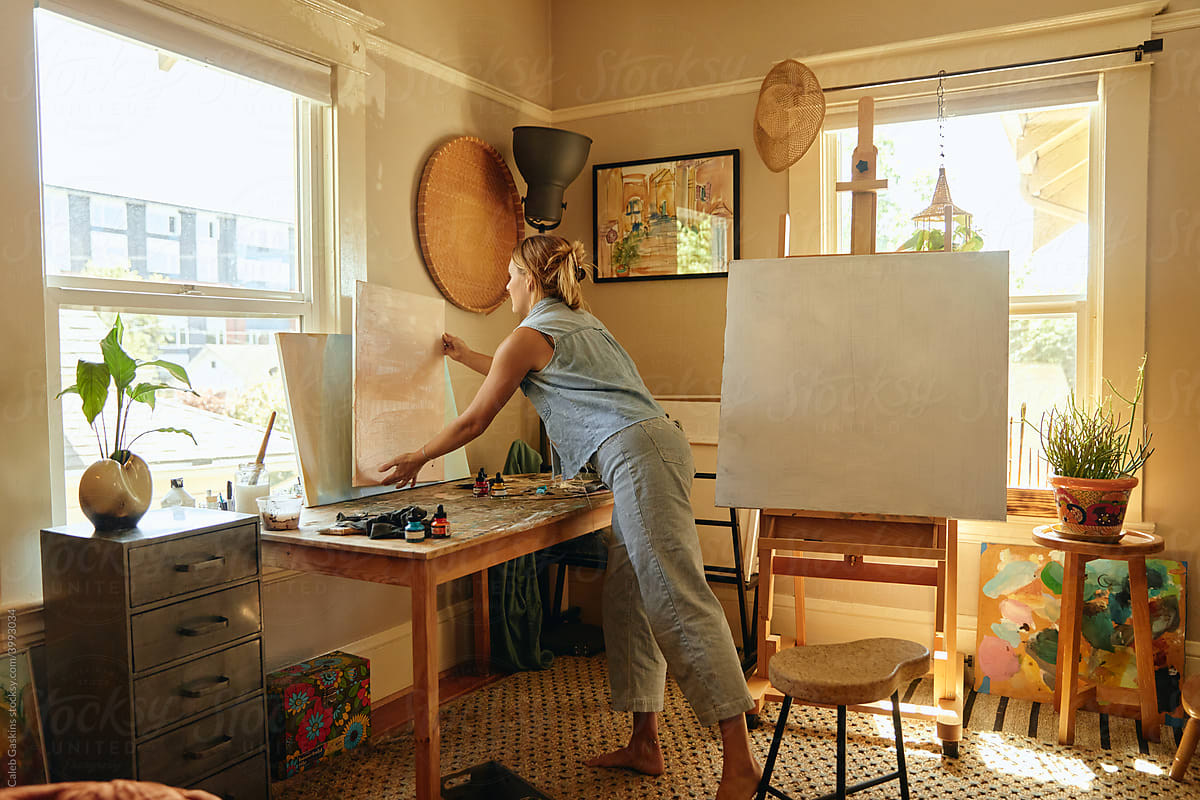Woman painting in a home studio.