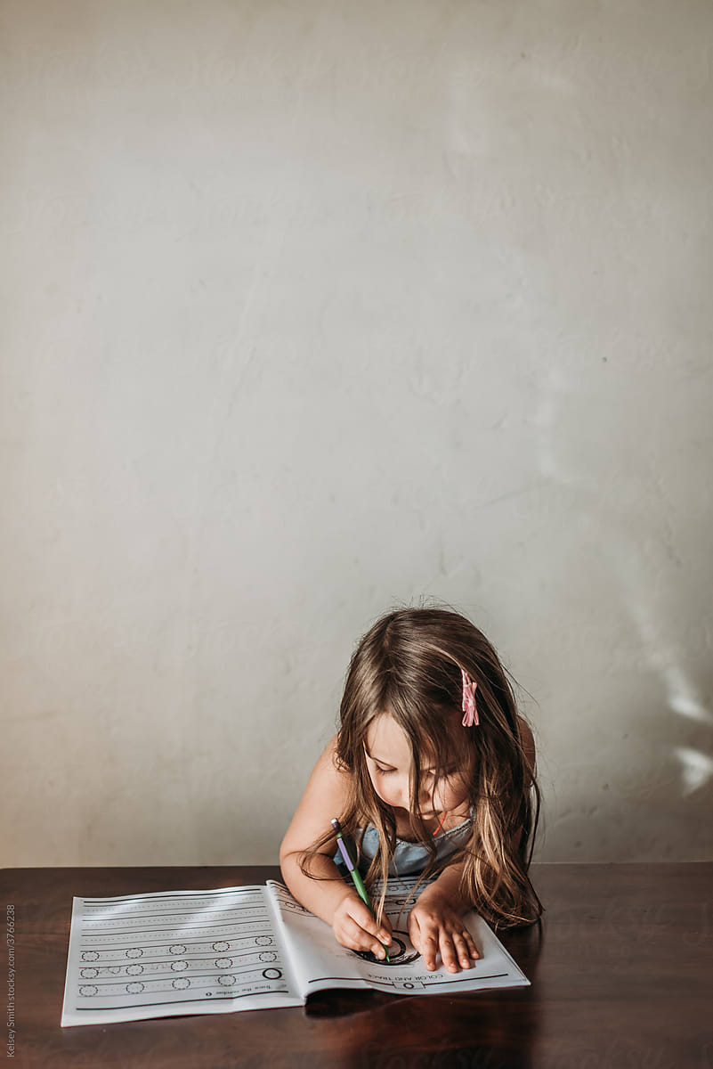 Girl coloring at home