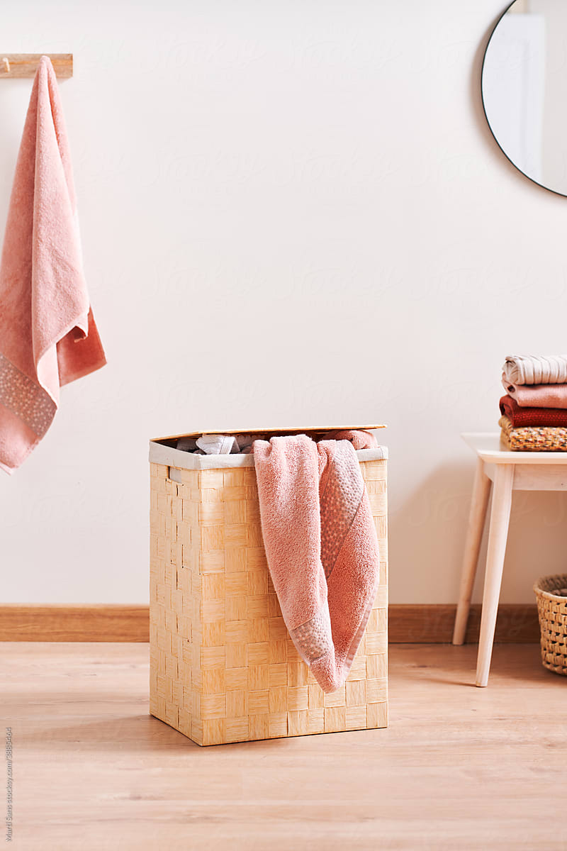 Eco-friendly basket with pink bath towel.