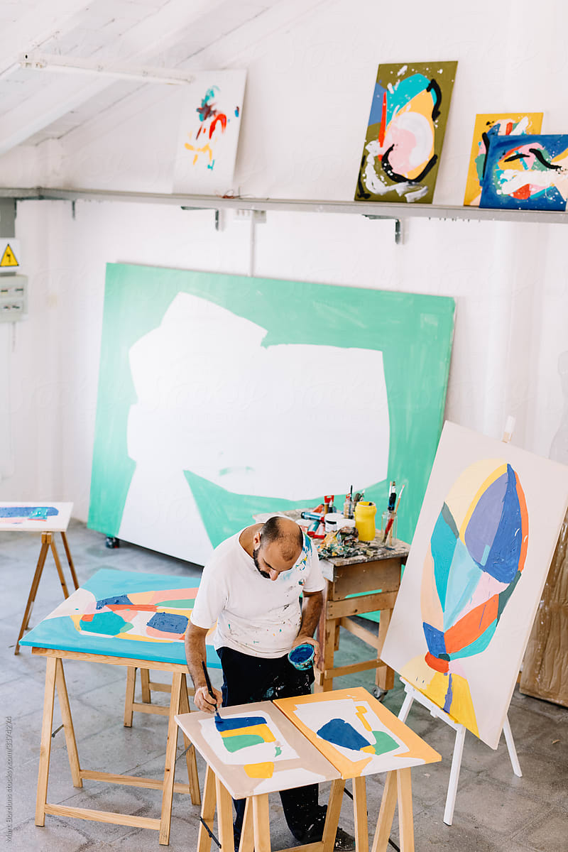 top view of a painter surrounded by his work
