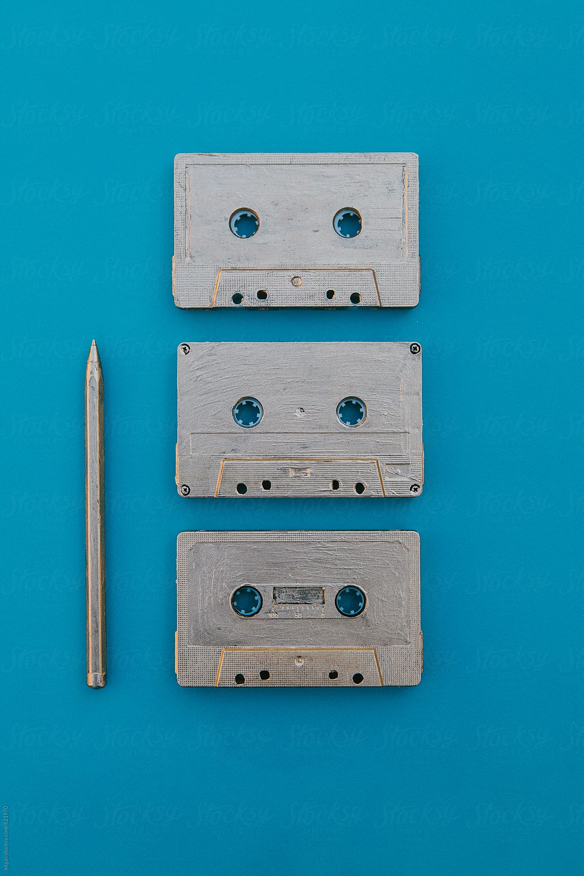 Gold cassette tapes and a rewinder pen