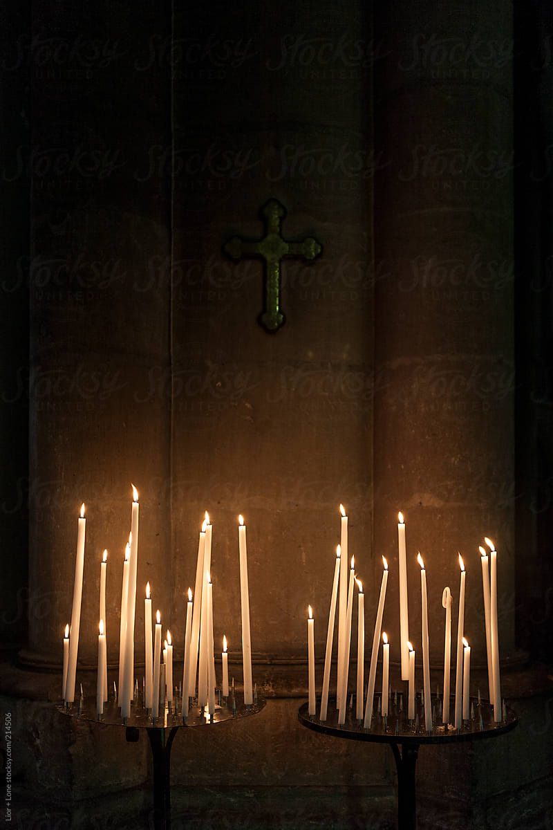 Cross and lit candles in church