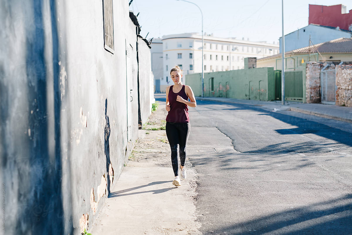 Woman running down street