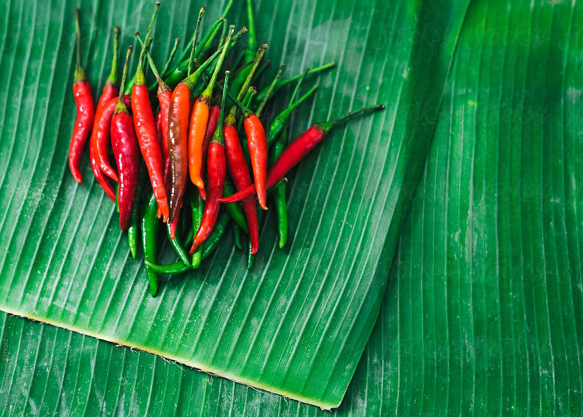 red and green chilli on banana leaf