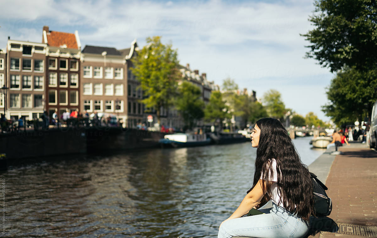 Young woman visiting the canals of Amsterdam