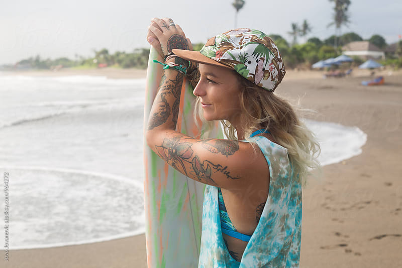 Portrait of a beautiful tattooed surfer woman