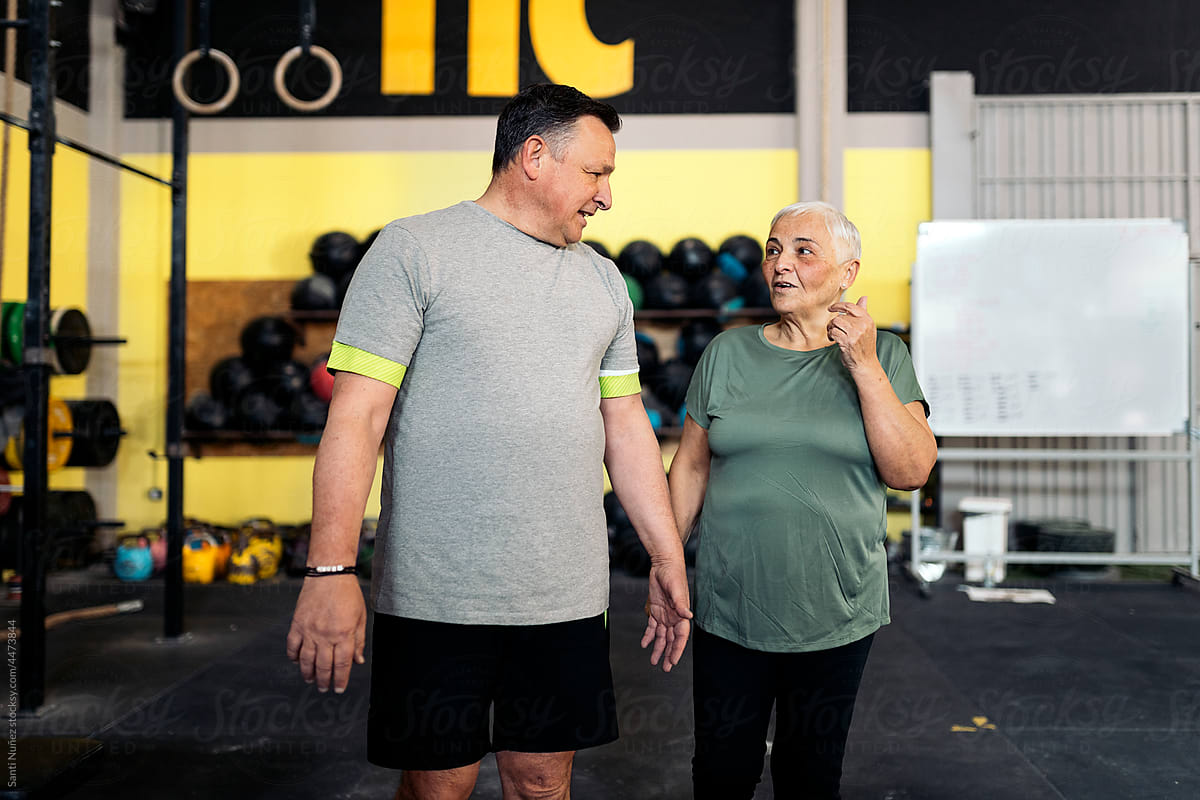 Mature couple speaking in gym
