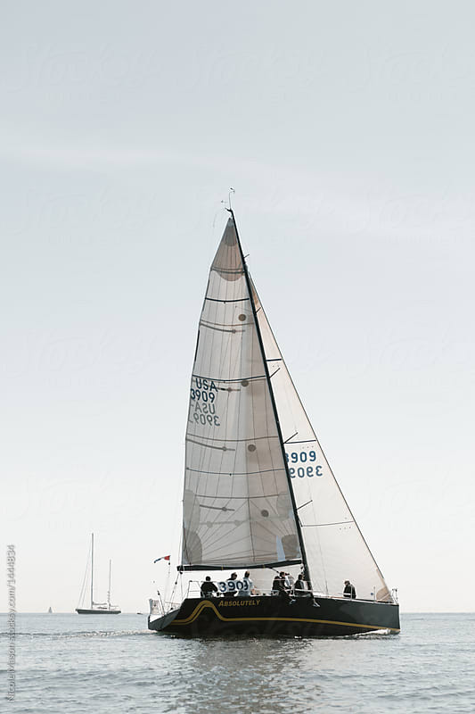 sailboat with crew members on board preparing for yacht race