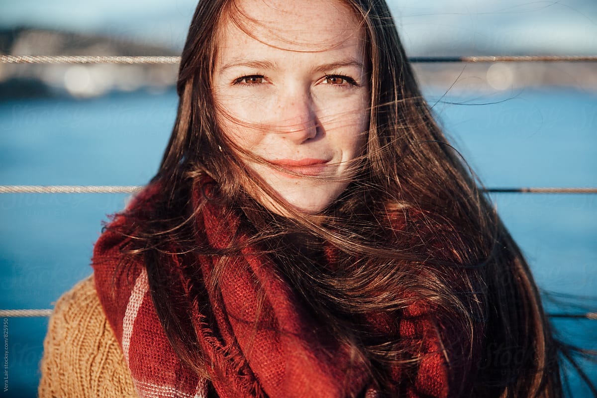 Portrait Of Young Woman With Freckles Looking At Camera By Stocksy