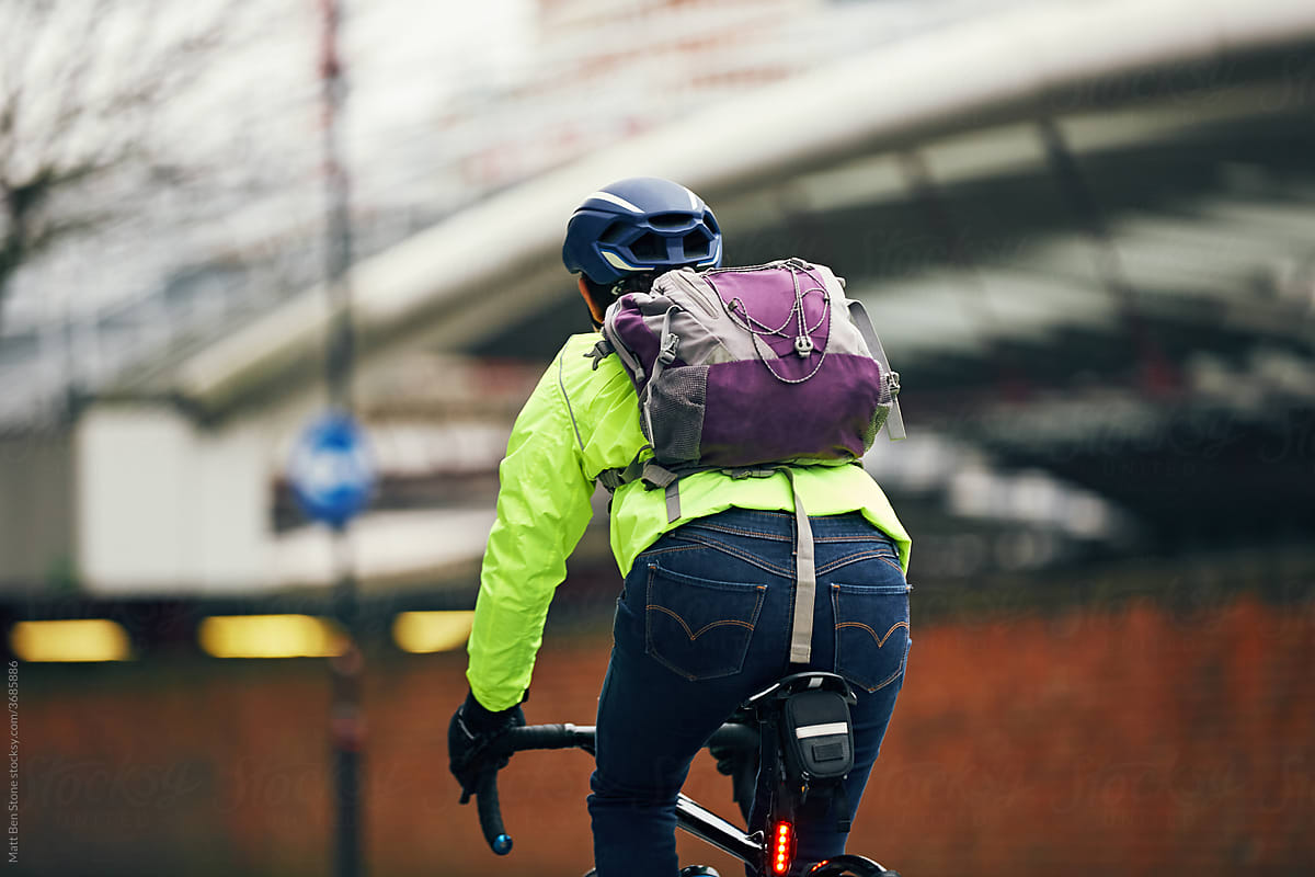 Commuter cyclist wearing high vis jacket cycling to work